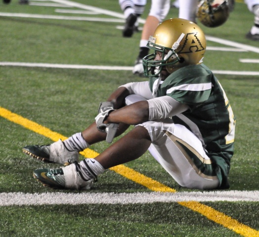 A dejected Darnell Hagans sits near the goal line after Auburn's 8-7 loss to Thomas Jefferson.