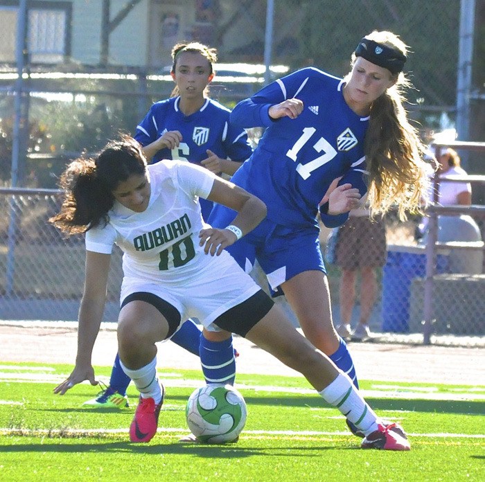 Auburn's Linda Karout tries to keep the ball away from a pair of Tahoma players.