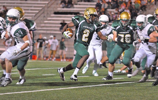 Auburn's Avery Wade scrambles for yardage against Peninsula on Friday night.