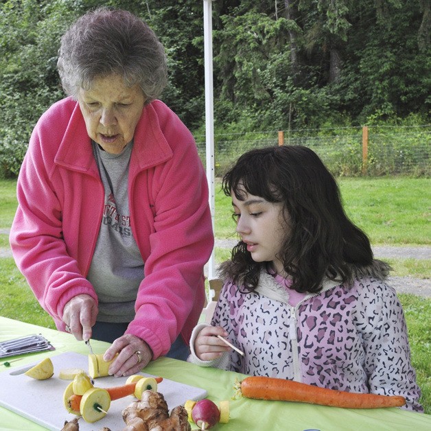 Barbara Saelid helps her granddaughter