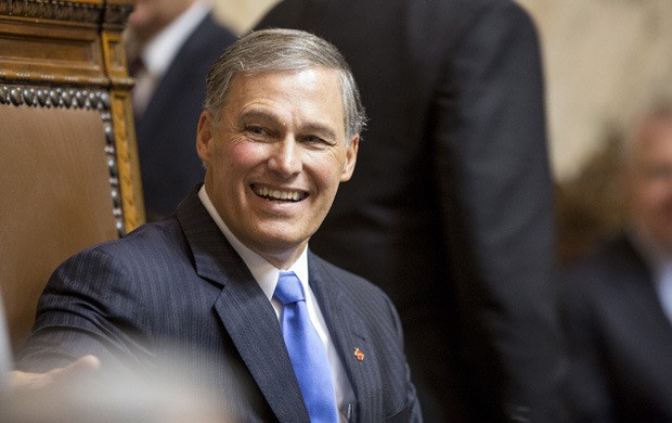 Gov. Jay Inslee smiles at the front of the rostrum on the House floor minutes before his Inaugural address Wednesday.