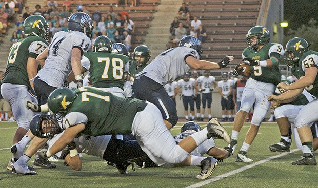 The Auburn Riverside defense collapses on Kentridge ball carrier Carter Johnson during Thursday night SPSL action at French Field.