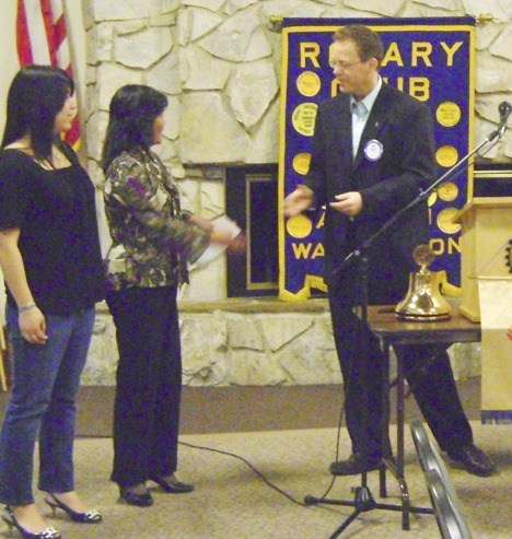 Accepting a check from Rotary president Terry Davis was Noel Oda's mother