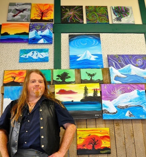 Christopher Horn shows his paintings on Main Street during the Auburn Art Walk and Wine Tasting event.