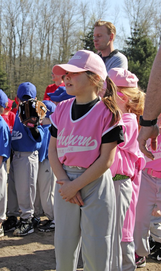 A member of the Peaches prepares to recite the Little League Pledge during the opening ceremonies for the Auburn Little League. More than 400 players and 34 teams were on hand at Brannan Park to kick off the season last Saturday.