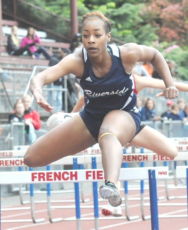 Auburn Riverside senior Rachel O'Neil competes in the 100-meter hurdles at the West Central District III/Southwest District 4 meet at French Field in Kent.