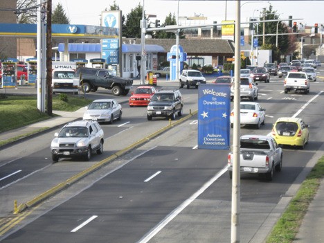 Late-afternoon traffic mounts along one of Auburn’s busiest streets