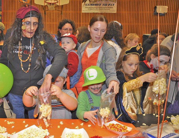 Kids in costumes enjoy art craft and some treats at the Halloween Festival at Washington Elementary School last Saturday. The festival included games