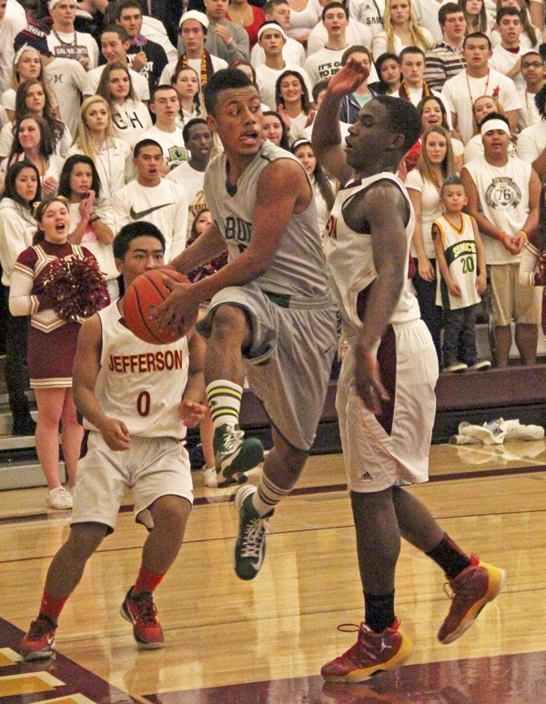 Auburn's JJ Ruffin splits a pair of defenders on his way to the hoop.