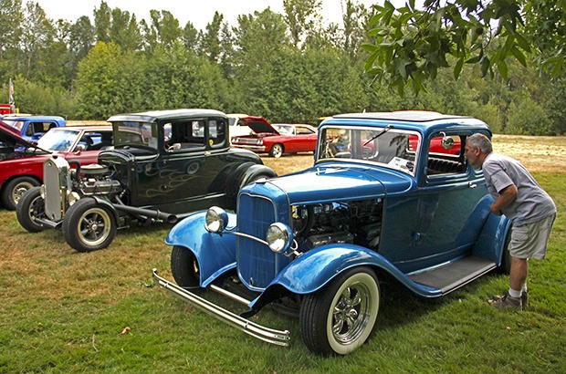 Auburn's Mike Bodine checks out a pair of early 1930s Ford five-window coupes at the Terry Home Show and Shine at Pacific City Park last  year. The show returns to the park