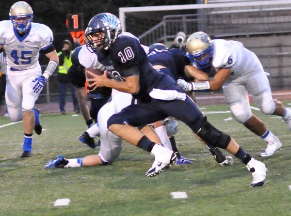 Auburn Riverside senior quarterback Kevin Thomson takes to the ground against Tahoma.