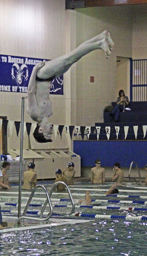 Max Barton dives off the springboard prior to a competition at Rogers High School in Puyallup.