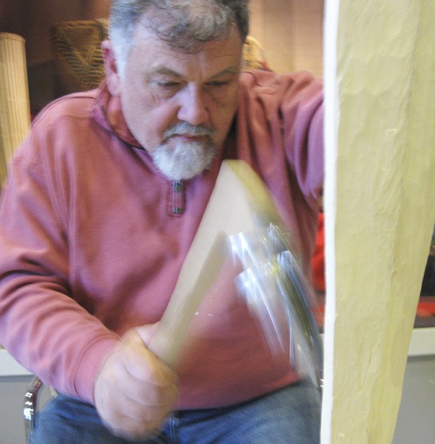 Greg Watson demonstrates the technique of adzing at the White River Valley Museum. Watson