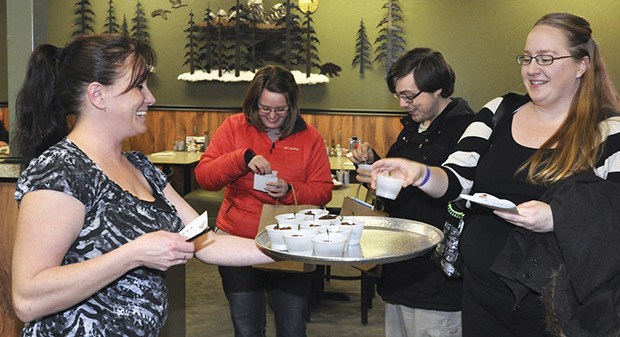 Stacy Whites from Rainbow Café gives chocolate to Katie Lembra