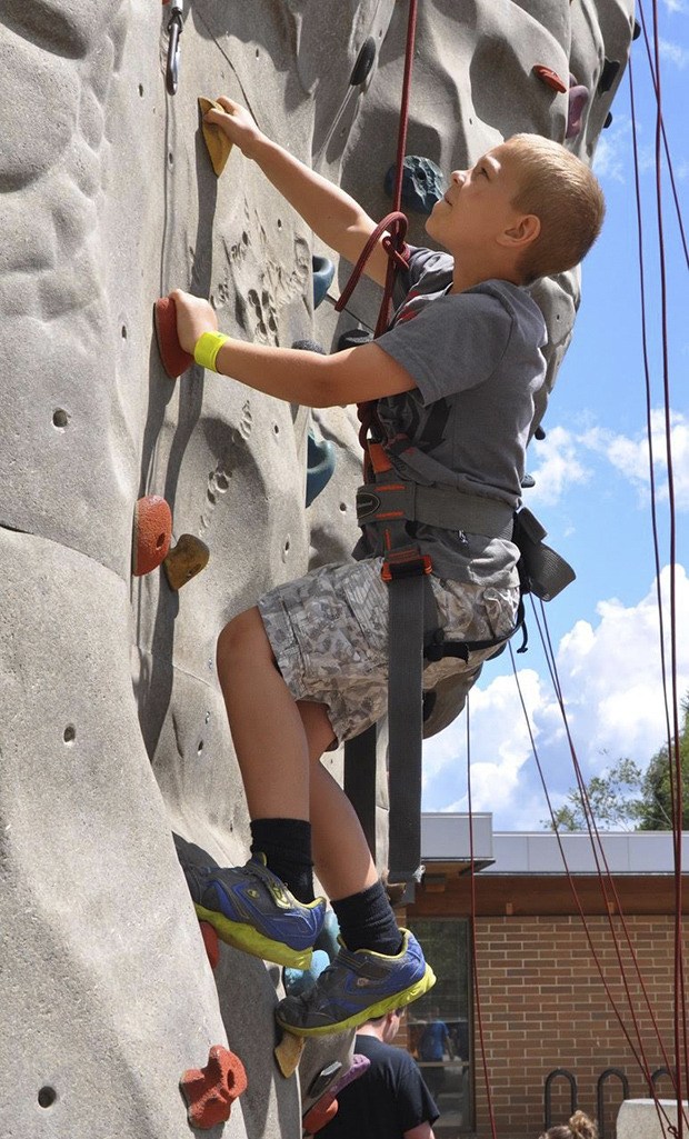 Brian Rozario scales the climbing wall at Les Gove Park during KidsDay last year. The event returns to the park June 24