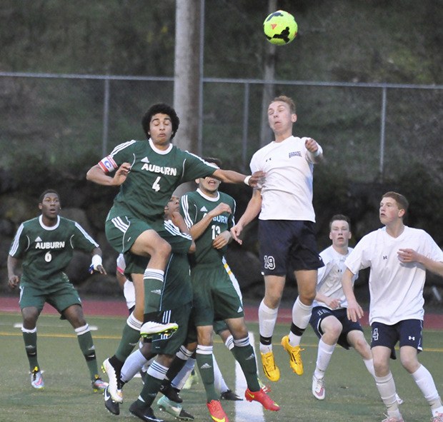 Auburn's Logan Jones (4) and Auburn Riverside's Noah Runsvold (19) vie for the ball during SPSL 3A play Wednesday.