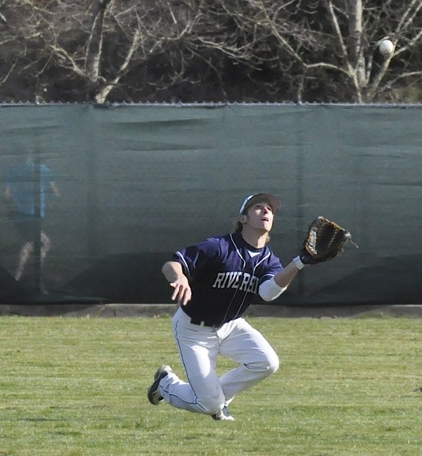 Auburn Riverside senior co-captain John Hakala tracks down a fly ball.