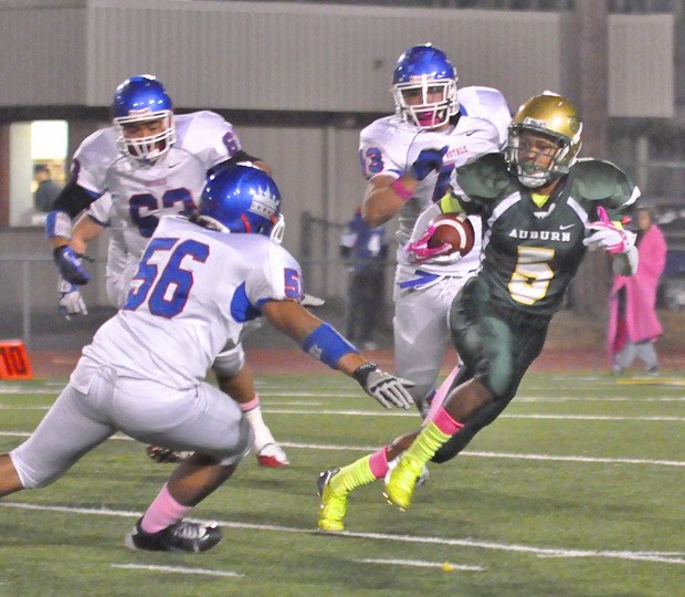 Harold Lee tries to escape the Kent-Meridian defense during Auburn's 35-14 win Thursday night.