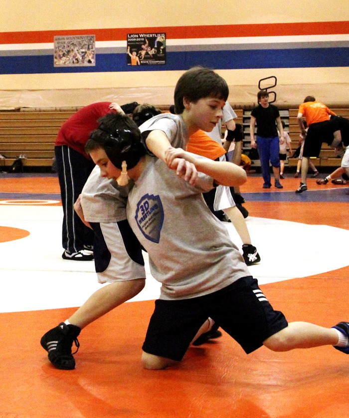 Cameron Foust and Gabe Sena practice their takedowns at Auburn Mountainview High School with the 3D Wrestling Club.