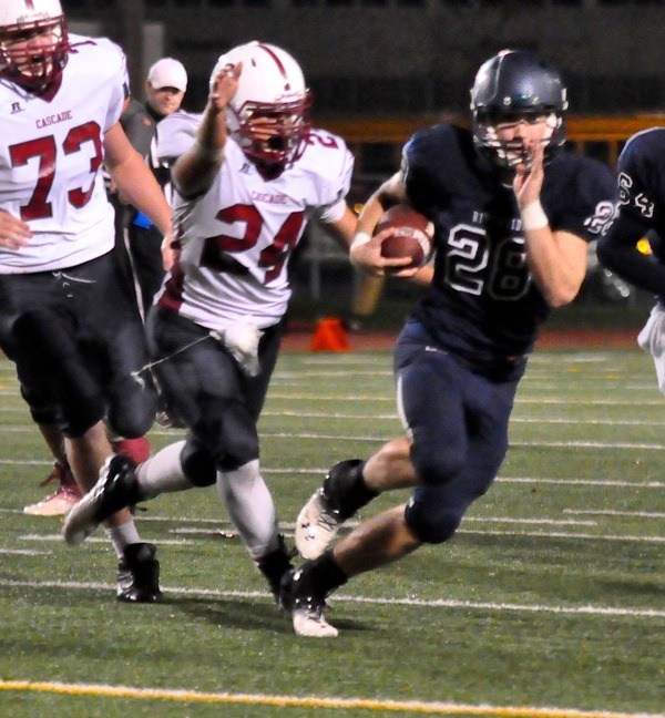 Cole Huckaby tries to outrun the Cascade defense Friday at Auburn Memorial Stadium.