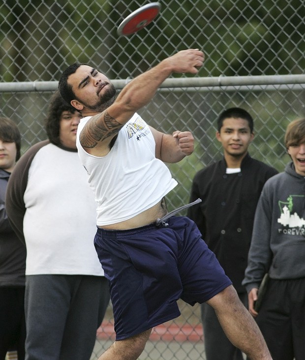 Senior Nick Conlan draws a crowd as he practices the discus at Auburn Memorial Stadium.