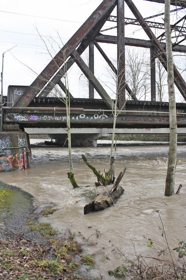 The White River runs swift and high under the A Street bridge in Pacific following a winter storm a year ago.