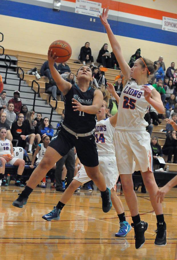 Auburn Riverside's Olivia Denton splits the Auburn Mountainview defense to score two of her 11 points Friday night. The Ravens went on to deliver a 60-37 SPSL 3A victory.