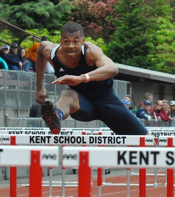 Auburn Riverside's Josh Turner competes in the 100-meter hurdles at the West Central District III/Southwest District 4 Track and Field meet at French Field in Kent.