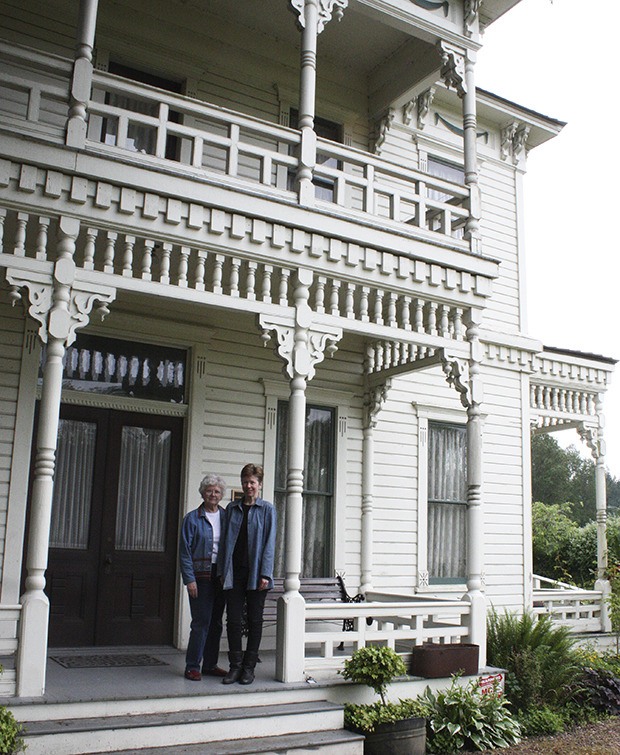 Neely Mansion Association's Pat Hallowell and historian and Association of King County Historical Organizations Board of Trustees member Karen Meador on the porch of the Neely Mansion.