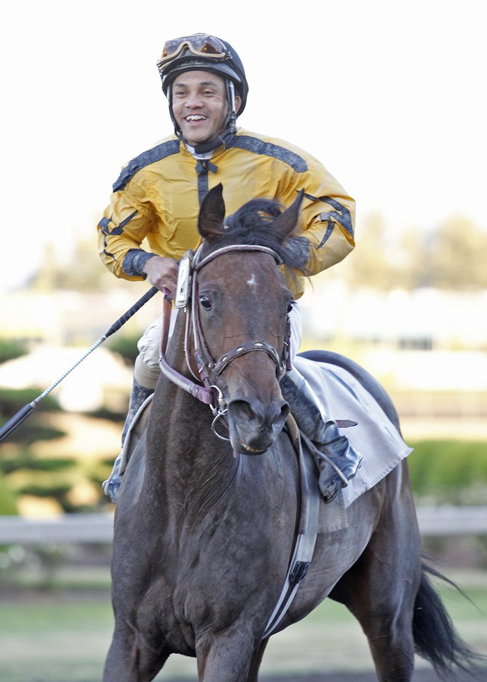 Leslie Mawing and 3-year-old filly Grand Baylee head back to the winner's circle following a neck victory in the fifth race at Emerald Downs