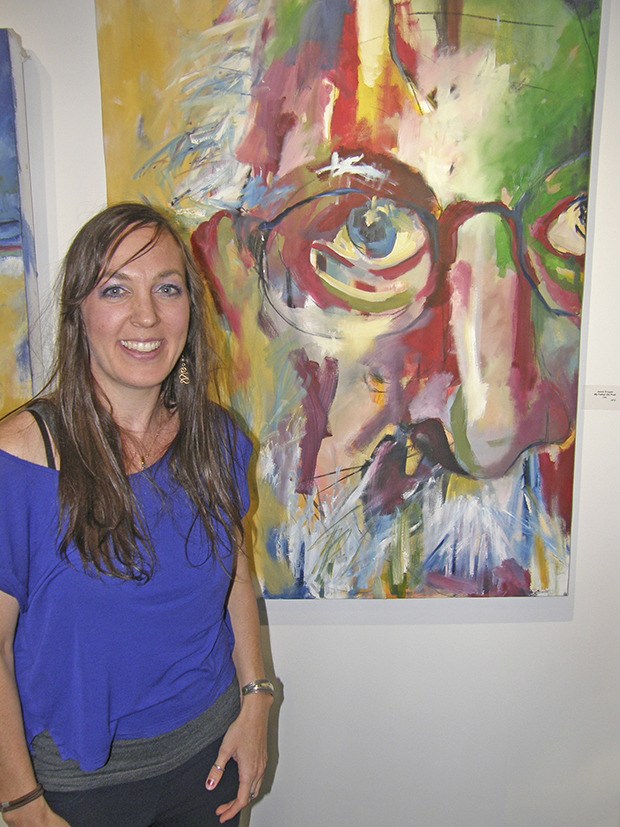 Artist Jessie Brugger displays one of her many paintings