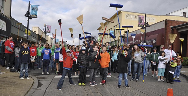 Volunteers join City and community leaders in cleaning up Main Street last Saturday.