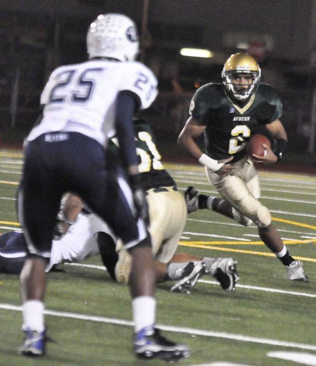 Auburn's Alphonse Wade looks for running room past Auburn Riverside's Cole Luckett during SPSL 4A play Thursday night.