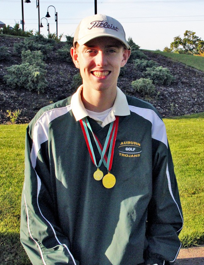 Auburn junior Tyler May shows off his gold medals from this summer's Special Olympic games.