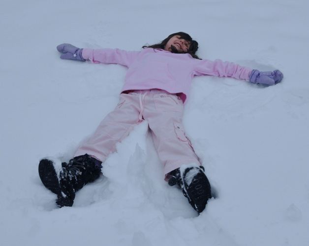 Auburn's Rhonya Qasem makes a snow angel on Wednesday afternoon. A major snowstorm blanketed the region on Wednesday