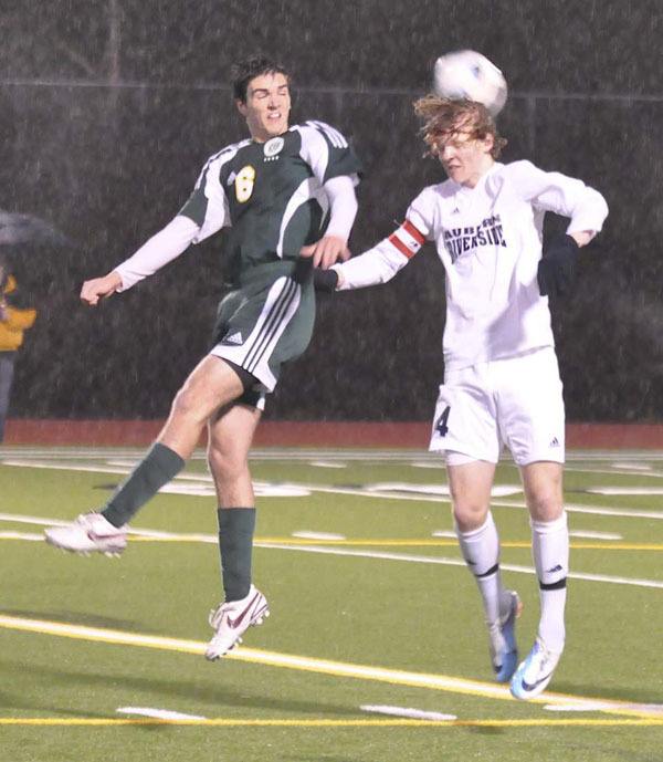 Auburn Riverside senior co-captain Kevin Wien heads a ball during the team's game against Kentlake this past week.