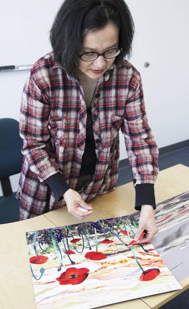 Carol Chen Lord demonstrates her collage technique on an image depicting flowers called ‘Sun Bathing.’