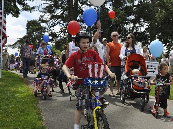 The bicycle parade gets underway at the Auburn's 2014 Fourth of July celebration.