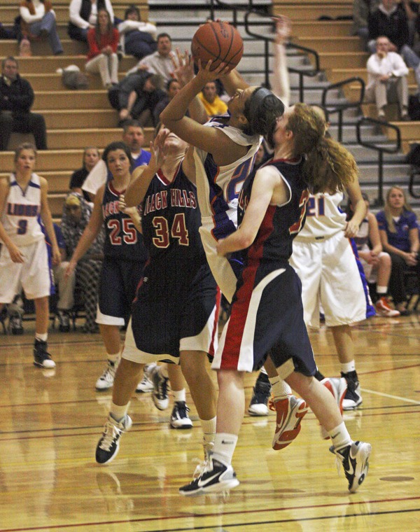 Sophomore Aalia Braboy muscles between two Black Hills defenders during a nonleague game.