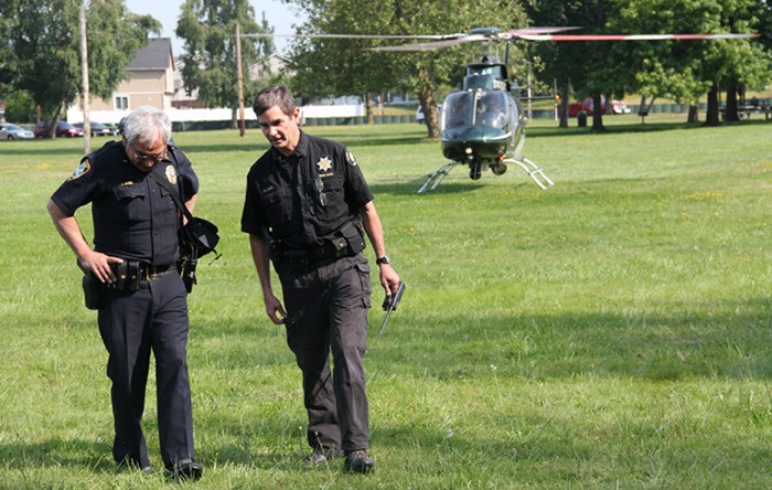 Pacific Police Lt. Edwin Massey confers with King County Sheriff's Deputy Peter Linde after an aerial search of the White River for Tatyana Khmara