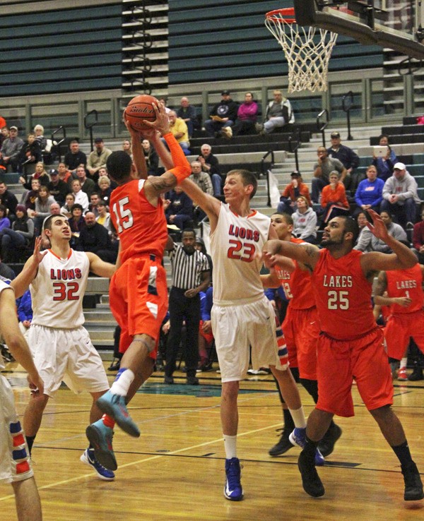 Auburn Mountainview's Tristan Miguel defends Lakes’ Sammie Long as Domenic Rockey looks on.