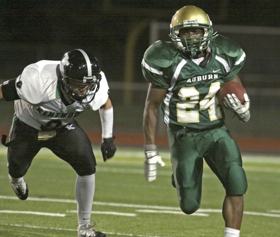 Auburn junior Darnell Hagans scampers away from Kentwood's Jesse Lovato.