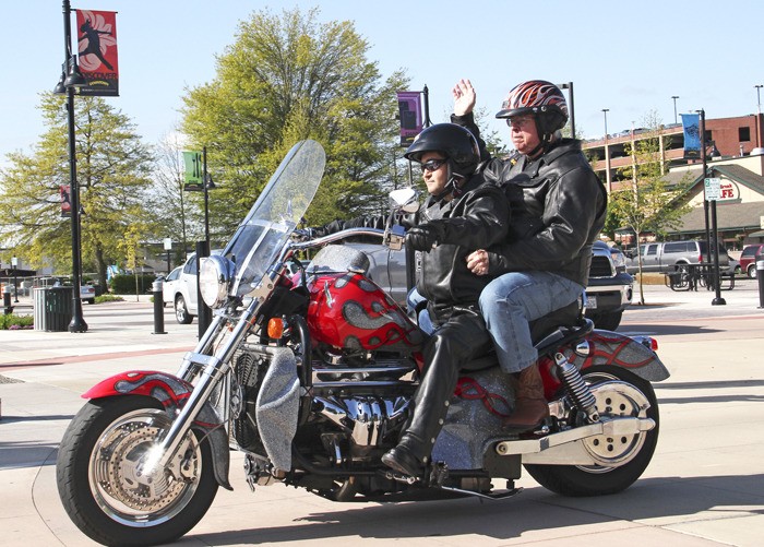 Eagle Leather owner Mike Toursal takes Auburn Mayor Pete Lewis for spin on his Boss Hoss