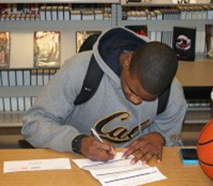 Auburn Riveriside's Cole Luckett signs his letter of intent to play basketball at North Idaho College next year.