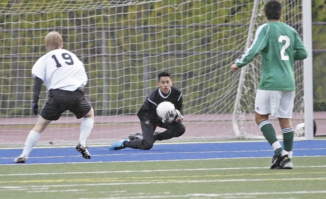 Juan Monroy makes a save for the Auburn boys soccer team against Kentlake at French Field.