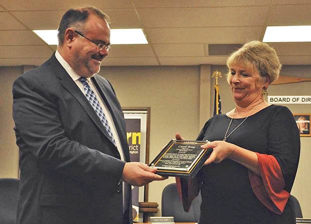 Auburn School District Superintendent Dr. Alan Spicciati gives Carol Seng an award for her exemplary work on the school board.