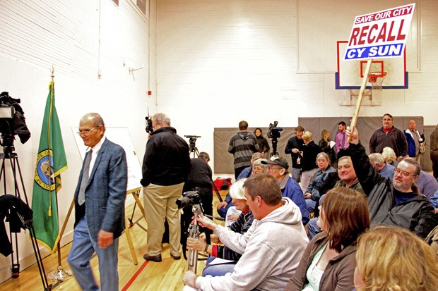 Pacific Mayor Cy Sun walks away after confronting a Committee to Recall Cy Sun supporter at Monday’s special meeting at the city gym. Sun later left the meeting after his address to the audience was stopped on a point of order.