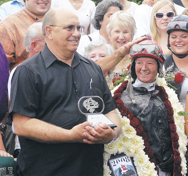 Trainer Howard Belvoir in the winner's circle with jockey Jennifer Whitaker.