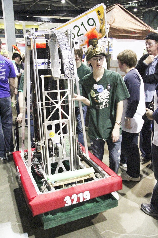 Auburn High School TREAD robotics team 3219 members Kyle Cheney (in helmet) and Brandon Olson wheel out their robot during the FIRST Robotics Seattle Regional Competition last weekend at the Qwest Events Center. The Auburn High School TREAD Robotics team 3219 and Auburn Mountainview’s Robotics Club Team 2907 earned spots in the semifinals at the competition. Auburn Mountainview finished tied for third-place overall with a 7-3-0 record