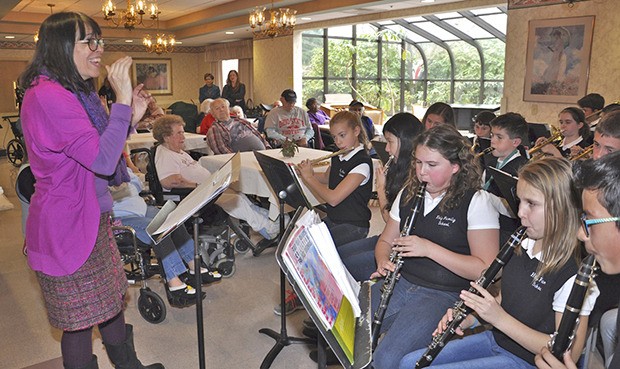 Deanna Reitan directs the Holy Family Middle School Band. The students are